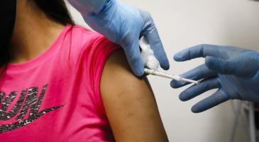 Health worker injects a person during clinical trials for a COVID-19 vaccine at Research Centers of America in Hollywood, Fla., on September 9, 2020.