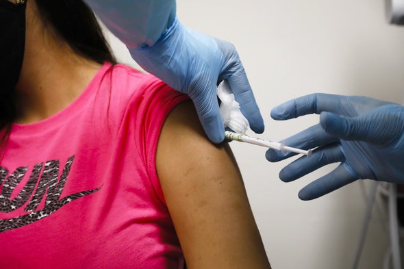 Health worker injects a person during clinical trials for a COVID-19 vaccine at Research Centers of America in Hollywood, Fla., on September 9, 2020.