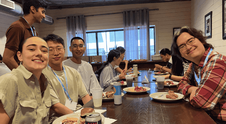 Photo of students and alumni gathering at the 2025 UW Reception at JSM