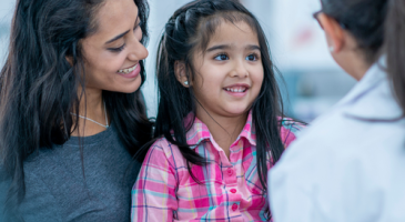 Mother and daughter meet with family doctor