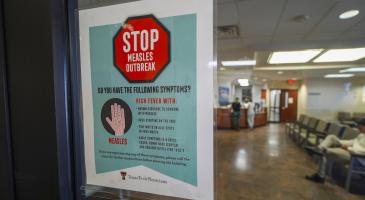 A sign warning of measles is posted on a glass door as a patients wait in the family medicine wing of at the Texas Tech Physicians of the Permian Basin Monday, Feb. 24, 2025, in Odessa, Texas. (AP)