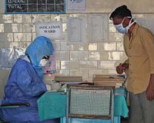 Photo of healthcare workers with protective gear and masks during virus outbreak in India