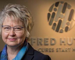 Photo of Garnet Anderson in front of Fred Hutch logo