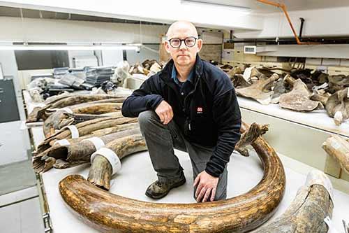 Mat Wooler portrait with tusk fossils