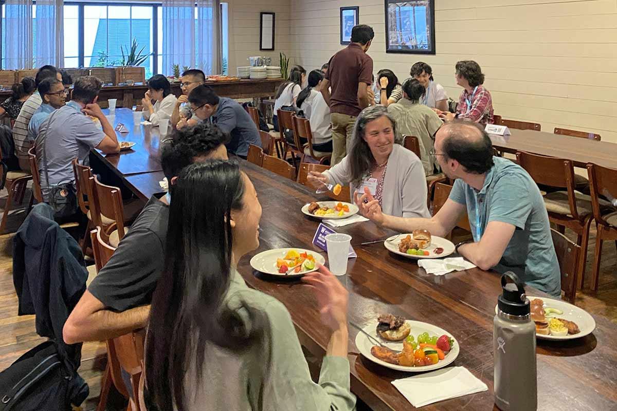 Attendees sharing food at the 2025 UW alumni reception for Biostatistics and Statistics