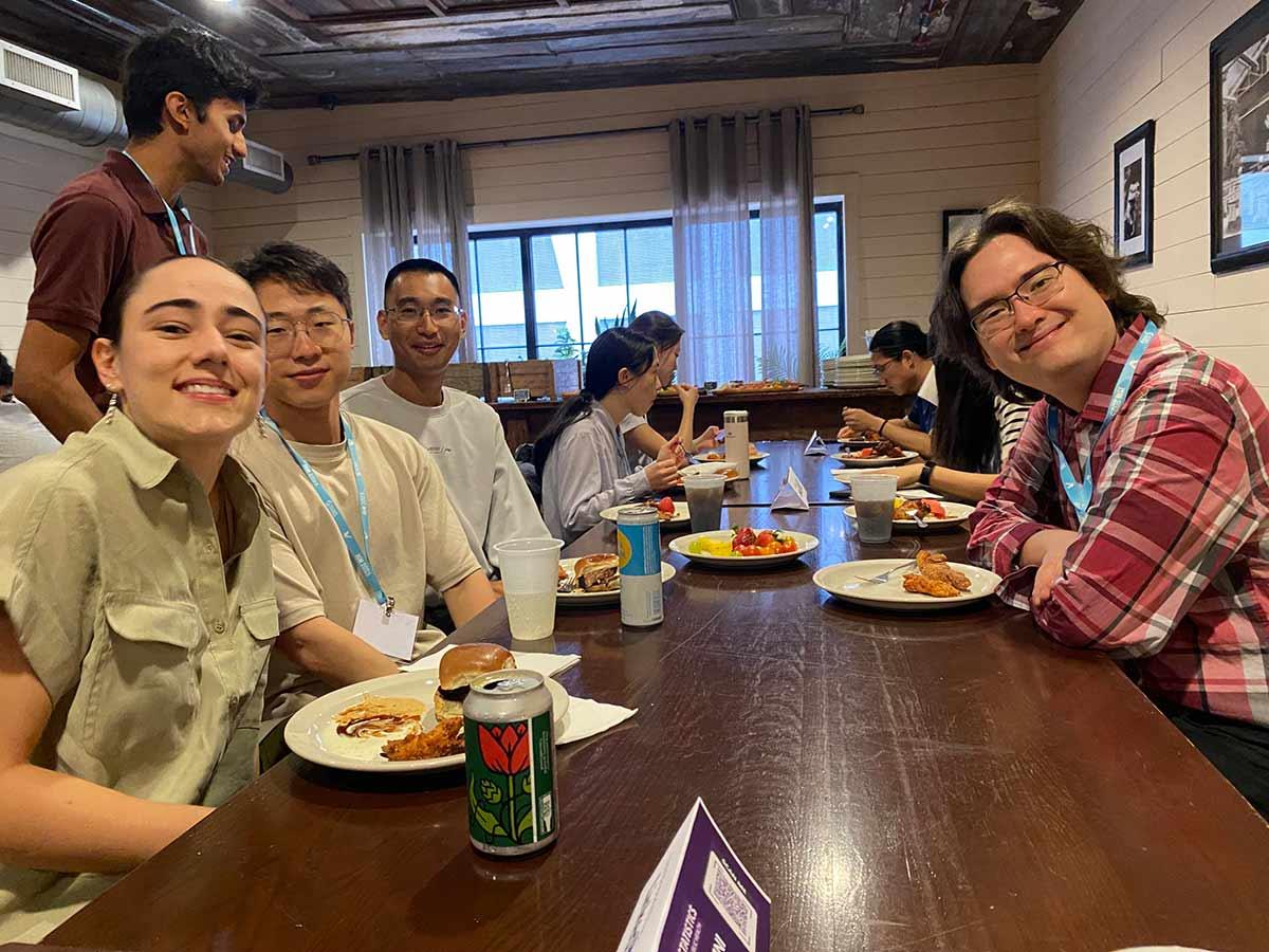 Attendees sharing food at the 2025 UW alumni reception for Biostatistics and Statistics