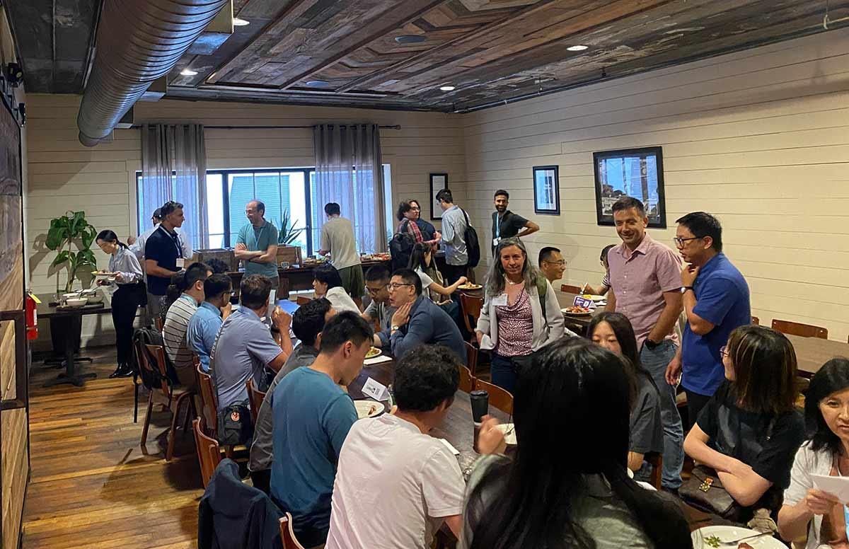 Attendees sharing food at the 2025 UW alumni reception for Biostatistics and Statistics