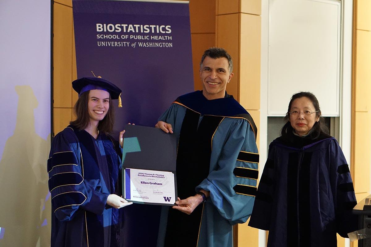 Ellen Graham holds award, pictured with Ali Shojaie and Lurdes Inoue
