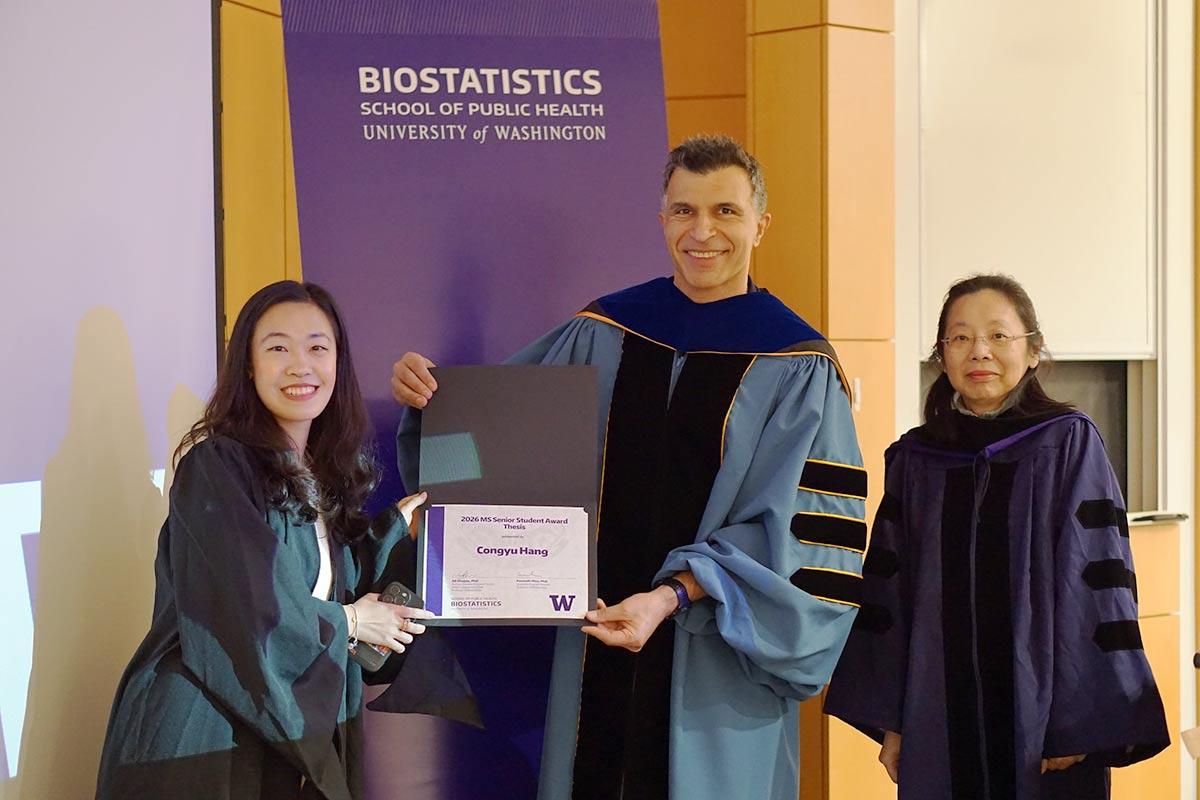 Congyu Hang holds award, pictured with Ali Shojaie and Lurdes Inoue