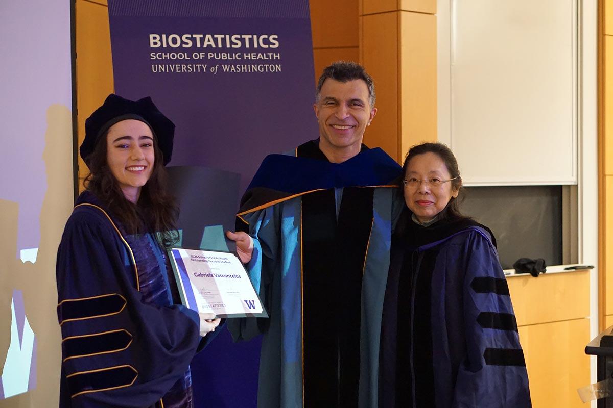 Gabriela Vasconcelos holds award, pictured with Ali Shojaie and Lurdes Inoue