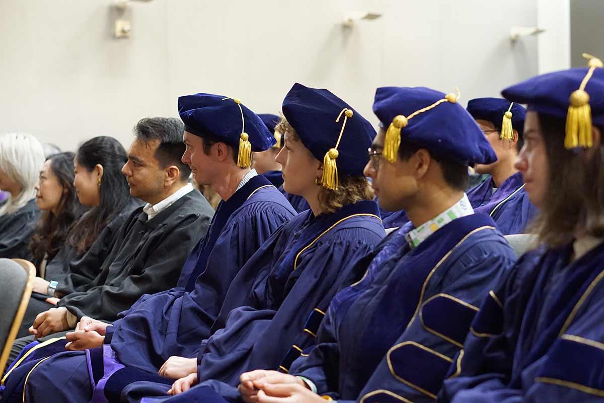 Students listening to graduation address during UW Biostatistics graduation